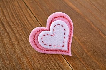 Felt heart on a wooden background. Valentines day.
