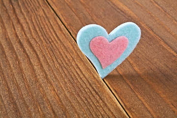 Obraz na płótnie Canvas Felt heart on a wooden background. Valentines day.