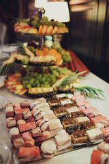 delicious colorful macaroons and cakes on the wedding candy bar