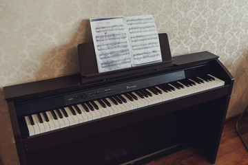 Fototapeta na wymiar sheets of notes standing on the beautiful black piano