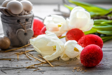 White tulips with pot and red Easter eggs