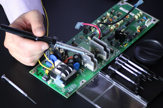 man hands chip soldering tools