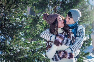 Couple in love hugs in winter park