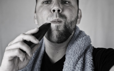 monochrome textured portrait bearded man shaving