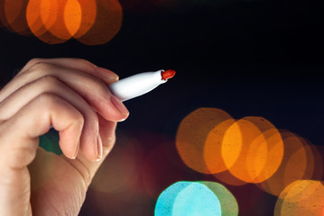 Female hand writing with red marker pen