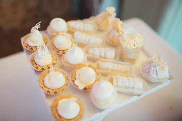 Tasty baked basckets with cream on white tray