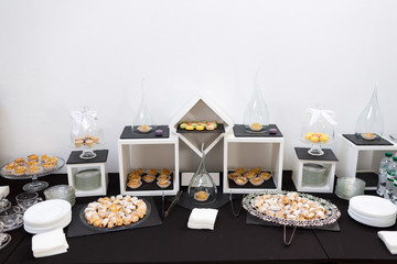 Tasty pastry served on black dishes on black table