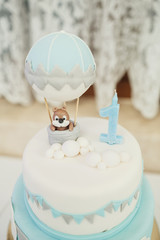 Baked balloon and candle in form of number one on pretty birthda