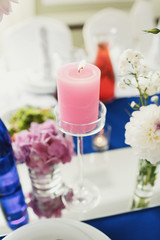Obraz na płótnie Canvas Glass candleholder and pink candle on it