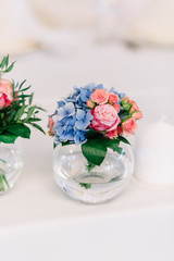 Little bowl with tiny roses and blue hydrangeas