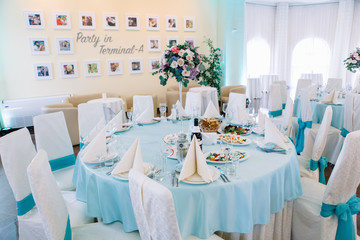 Blue dinner table with beautiful bouquet served for wedding part