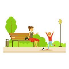 Mom Sitting On The Bench Wathing Her Son Playing Football, Part Of People In The Park Activities Series