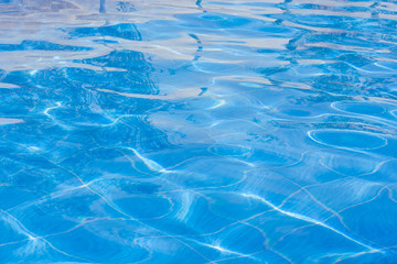 Blue swimming pool rippled water.