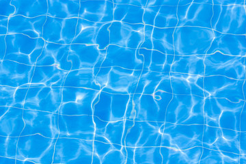 Blue swimming pool rippled water.