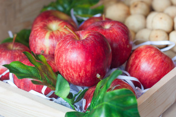 Ripe red apples in wood box.