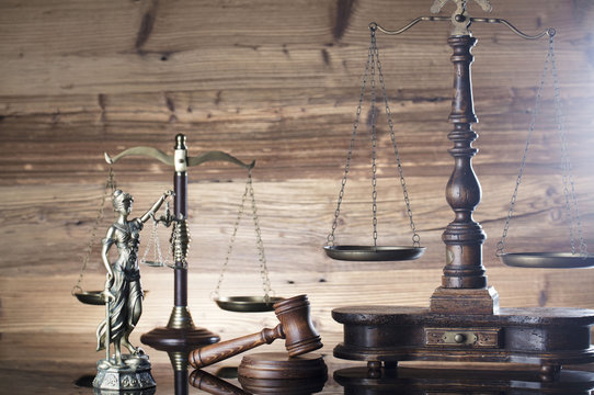Law and justice concept. Scales of justice, gavel, paragraphs, brown wooden background, place for text