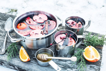 Christmas - hot mulled wine outdoor in a pot with snow around