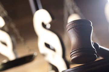 Law and justice concept. Scales of justice, gavel, paragraphs, brown wooden background, place for...