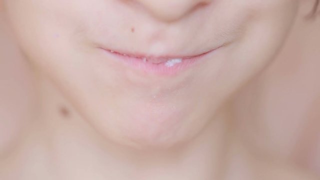 Close-up of a child receives food. eating. eats milk porridge spoon
