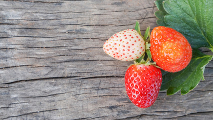 Fresh strawberries on old wooden background