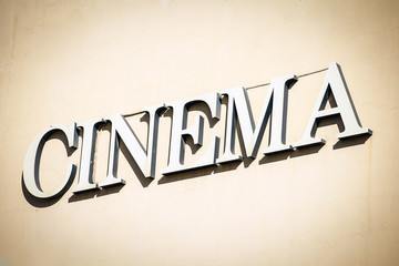 Fototapeta na wymiar Sign with letters pointing to cinema