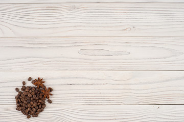 Coffee beans with star anise white on a wooden table.