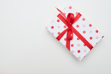 Big dotted gift box with red ribbon and bow tie