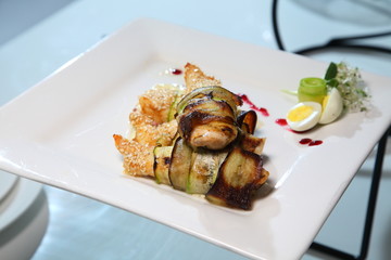 Fried chicken fillet wrapped in aubergine, cream sauce with spices and seasonings. Chicken with eggplant with creamy sauce. Roast chicken with eggplant.