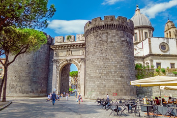 NAPLES, ITALY - AUGUST 7, 2016: The east side of the ancient city gate Porta Capuana. The gate...