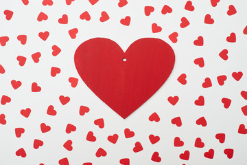 Red heart greeting card over flat layout designed with small hea