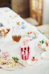 Pink box for pop-corn with number 1 on it stands on dinner table