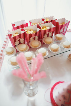 Pink boxes with pop-corn stand before glass plate with white mac