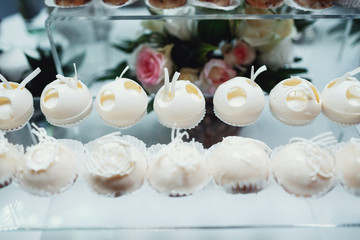 White chocolate balls stand on glass box