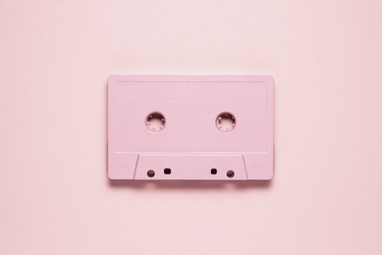 Retro wave / Creative photo of  painted cassette on pink  background.