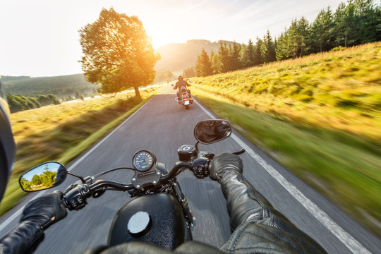 Fototapeta Driver riding motorcycle on an asphalt road