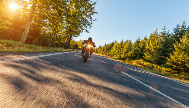 Fototapeta Motorcycle driver on road