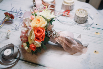 Crystal brooch put on wedding bouquet made of roses