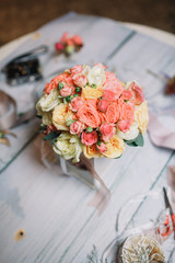 Look from above at bouquet of orange roses and orchids standing