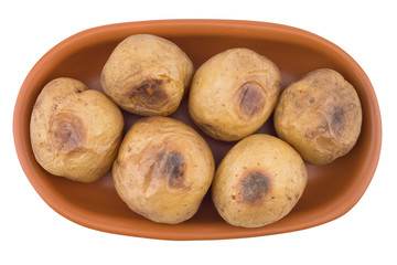 Baked potato in a brown plate isolated on white.