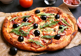 Pizza with tomato, salami and olives