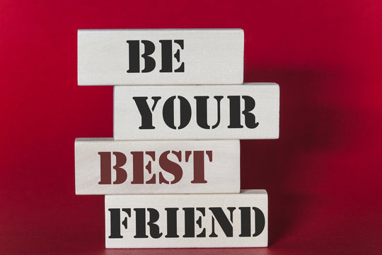 Be your best friend. Motivational quote written on wooden tiles