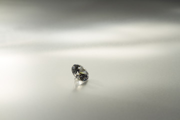 Beautiful big diamond jewelry on gray background. Fine natural precious stone.Brillant shine.