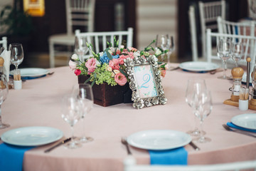 Number 2 put in steel frame with flowers stands before wooden fl