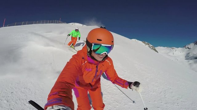 4k Skiing Footage, Woman Filming Selfie Point Of View With Two Skiers Following Her Down Ski Slope
