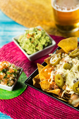 Tasty nachos with cheese and beer