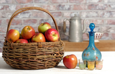 Basket with applesand carafe of calvados