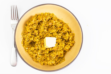 Lentil porridge with butter in a ceramic bowl on a white backgro