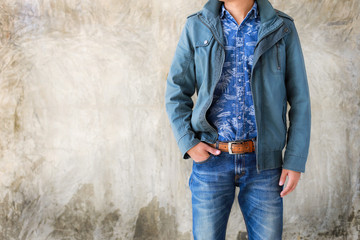 Closeup Men casual outfits standing and denims holds his hands in pockets. Concrete background with space for texture. men beauty and fashion concept, Jeans concept - 135420358