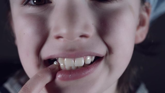4k Close Up Child Mouth Showing Wiggling Tooth