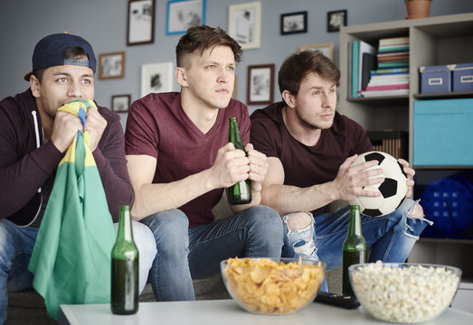 Soccer fans in the living room .